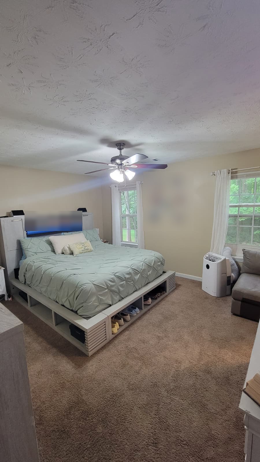 The same bedroom vacuumed, made up and tidied after cleaning